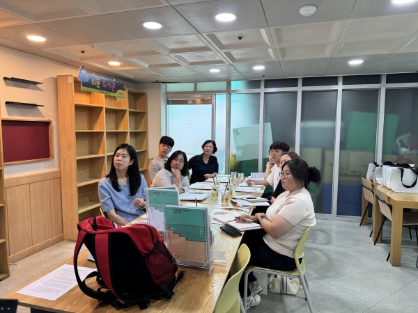 사회복지사의 설명을 앉아서 경청하는 사회복지사들